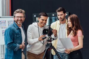 happy-art-director-smiling-near-coworkers